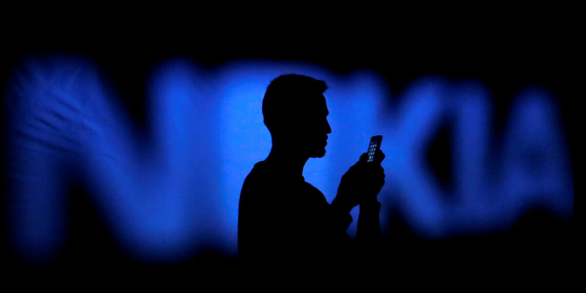 FILE PHOTO: A photo illustration of a man silhouetted against a Nokia logo in the central Bosnian town of Zenica January 23, 2014.      REUTERS/Dado Ruvic/File Photo - RTX3750K